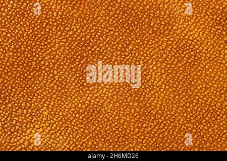 Texture of mottled golden brown genuine leather, trendy pattern Stock Photo