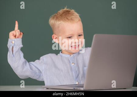 Amazed child using gadgets to study. Computer education for kids. Genius child programming, computer training. Stock Photo