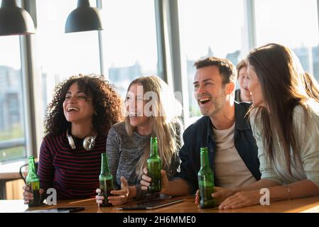 Excited business people sitting in office Stock Photo