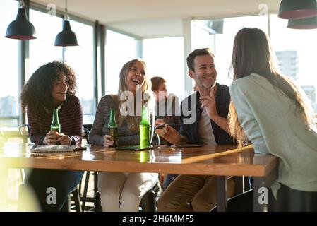 Office colleagues chatting in office Stock Photo