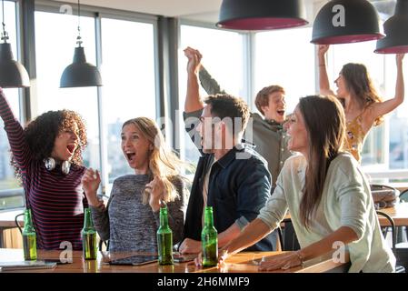 Excited business people celebrating in office Stock Photo