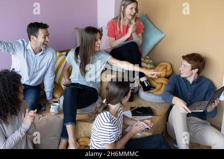 Business people clapping hands and celebrating in office Stock Photo
