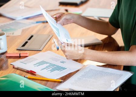 Close-up of businesswoman holding graph in office Stock Photo