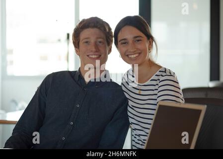Portrait of smiling business people sitting in office Stock Photo