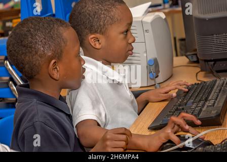Elementary school students use a computer on the last day of school, June 13, 2011, in Columbus, Mississippi. Stock Photo