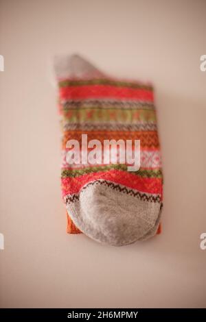 Warm winter socks with a beautiful pattern on a white table. Stock Photo