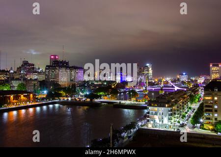 Elevated view of Puente de la Mujer and Puerto Madero waterfront at night Stock Photo