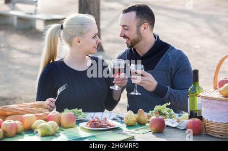 couple having picnic in sunny spring day at countryside Stock Photo