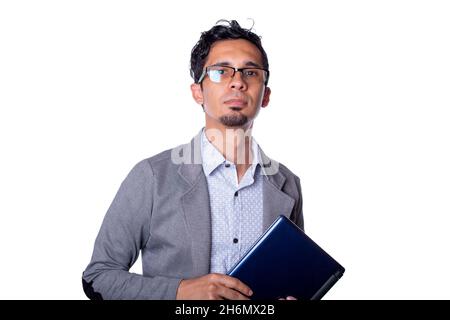 Young modern businessman holding laptop with his hands and looking at camera. man wearing glasses isolated on white background. Stock Photo