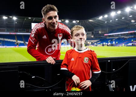 Cardiff, UK. 16th Nov, 2021. Harry Wilson of Wales poses with a young fan at full time. Wales v Belgium in a 2022 FIFA World Cup Qualifier at the Cardiff City Stadium on the 16th November 2021. Credit: Lewis Mitchell/Alamy Live News Stock Photo
