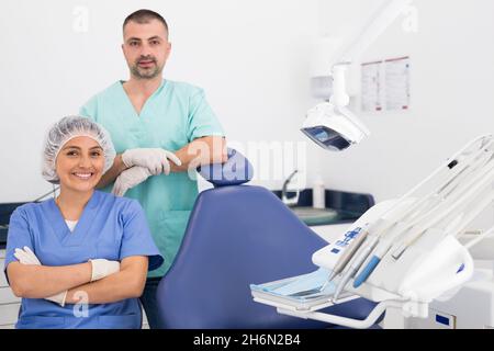 Handsome dentist with young female assistant in uniform Stock Photo