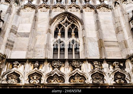 Arched window with marble frame on the facade of the Duomo. Italy, Milan Stock Photo