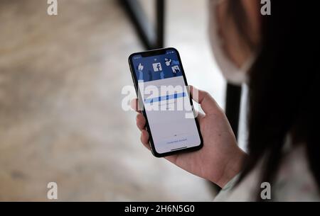 CHIANG MAI, THAILAND - NOV 14, 2021: Facebook social media app logo on log-in, sign-up registration page on mobile app screen on iPhone X in person's Stock Photo