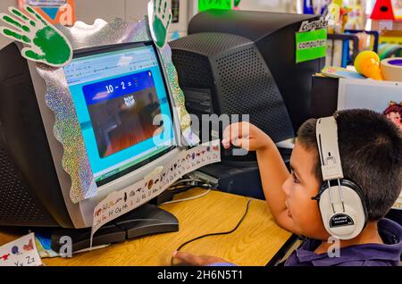 A pre-kindergarten student plays a math game on a computer in the classroom, May 18, 2012, in Columbus, Mississippi. Stock Photo