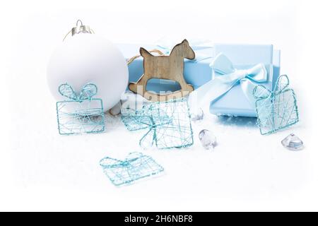 Christmas and newborn motifs on white snowy background Stock Photo