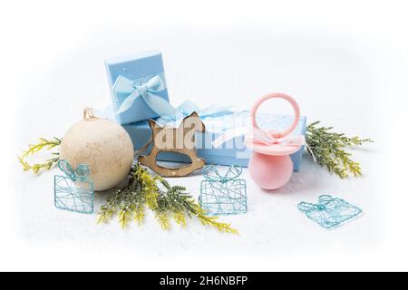 Christmas and newborn motifs on white snowy background Stock Photo