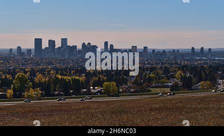 Beautiful cityscape of Calgary, Alberta, Canada in autumn season viewed from Nose Hill Park with colorful meadow, residential areas and skyline. Stock Photo