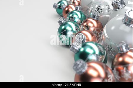 A collection of rose gold mint and white christmas baubles decorated with fine ornate snowflake patterns in silver on an isolated white background - 3 Stock Photo