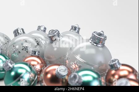 A collection of rose gold mint and white christmas baubles decorated with fine ornate snowflake patterns in silver on an isolated white background - 3 Stock Photo