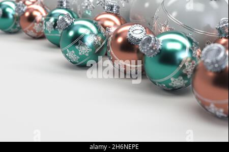 A collection of rose gold mint and white christmas baubles decorated with fine ornate snowflake patterns in silver on an isolated white background - 3 Stock Photo