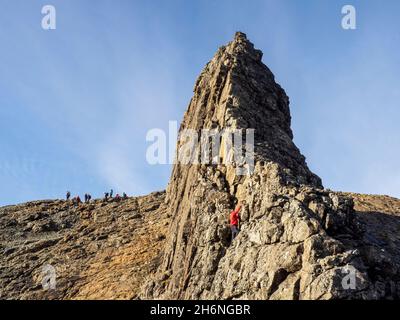 A climber soloing the Inaccessible Pinnacle on Sgurr Dearg on the Cuillin Ridge on the Isle of Skye, Scotland, UK. The In Pin is the hardest of all Sc Stock Photo