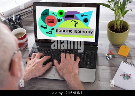 Robotic industry concept shown on a laptop used by a man Stock Photo