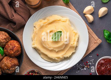 Lunch with mashed potatoes on a dark background. Top view, close-up. Stock Photo