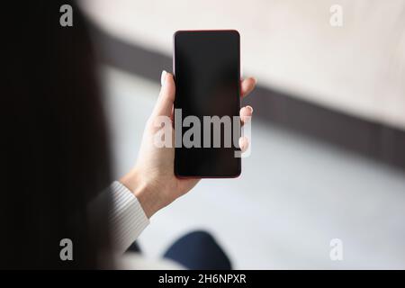 Woman hold smartphone with locked or turned off black screen Stock Photo