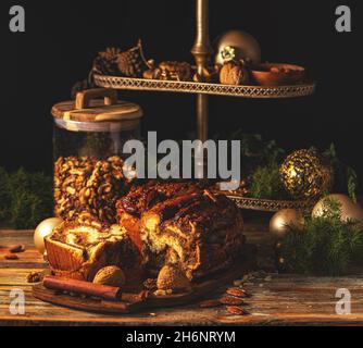 Nuts braided swirl bread Babka on the Christmas background Stock Photo