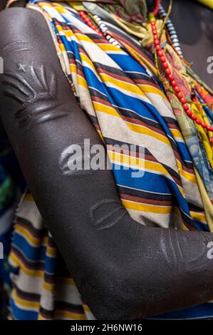 Woman with beauty scars from the Toposa tribe breastfeeding her baby, Eastern Equatoria, South Sudan Stock Photo