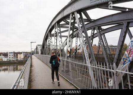 A young woman walking along a deserted Barnes Railway Bridge in southwest London, England, U.K. Stock Photo