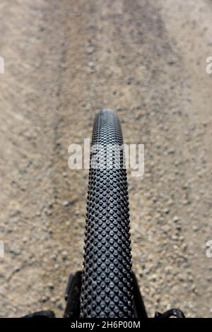 Close up of a gravel bike tire. Adventure on a gravelike bike. Photo taken on a beautiful sunny day. Stock Photo