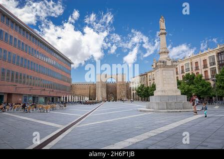 AVILA, SPAIN – JUNE 20, 2021: Views of the Mercado Grande Square, with de gate of The Alcazar at the back Stock Photo