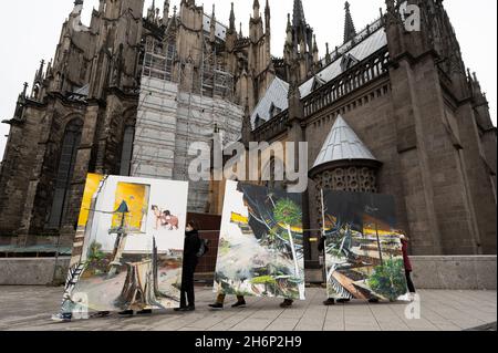 Cologne, Germany. 17th Nov, 2021. Climate activists carry the painting 'Das Gro?e Gelingen' from 2021 by the artist couple Helge & Saxana through Cologne towards Art Cologne. The action is intended to demonstrate against the demolition of the village of Lützerath, which is threatened by the Garzweiler open-cast lignite mine. Credit: Federico Gambarini/dpa/Alamy Live News Stock Photo