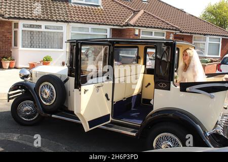 A bride in a wedding car on her wedding day Stock Photo