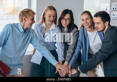 Business team showing unity with their hands together. Stock Photo