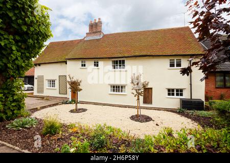 Stoke by Clare, England - October 17 2019: Detached British Cottage taken from the public road with tiled roof, large chimney and small windows Stock Photo