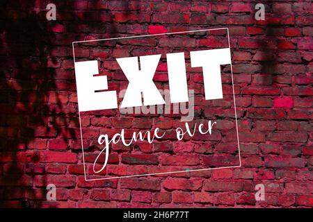 White exit word and game over. letters on brick wall. gaming concept Stock Photo