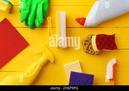 Cleaning tools composition flat lay on yellow wooden background Stock Photo