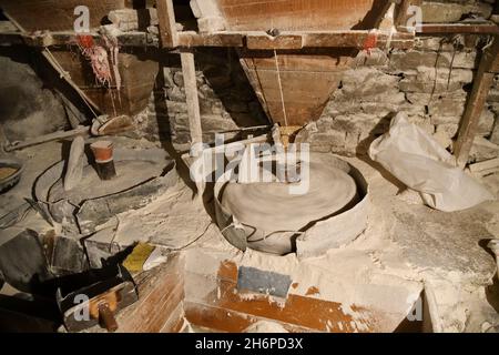 Watermill. Stone millstones spin and grinding corn kernels into flour. Medieval technology. Chechen Republic. Russia Stock Photo