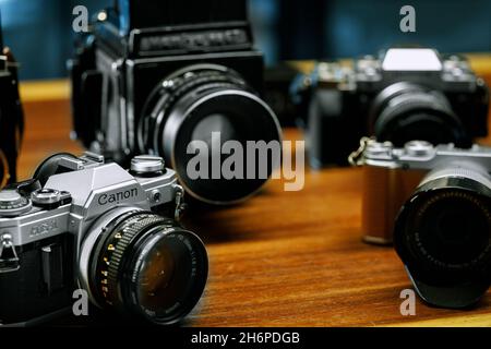 Izmir, Turkey - July 9, 2021: Illustrative editorial Close up shot of Canon AE1 analog film camera and other cameras defocused on the background. Stock Photo