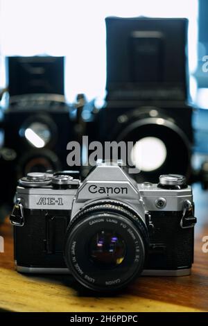 Izmir, Turkey - July 9, 2021: Illustrative editorial Close up shot of Canon AE1 analog film camera and other cameras defocused on the background. Stock Photo