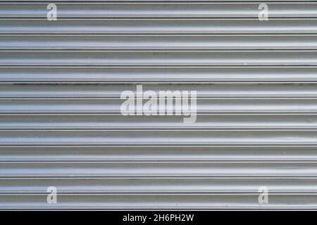 Close up of an aluminum door. Gray striped metal background made of aluminum. Stock Photo