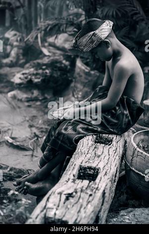 BANGKOK,THAILAND-FEBRUARY 19,2017: Dramatic young boy in Bali traditional costume in the ancient garden house. FEBRUARY.19.2017 Stock Photo