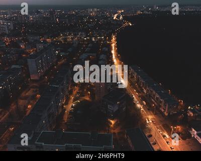 Aerial view of the illuminated streets and residential rooftops of ...