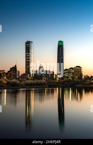 Pond at Bicentennial Park in the wealthy Vitacura district and skyline of buildings at financial district, Santiago de Chile Stock Photo