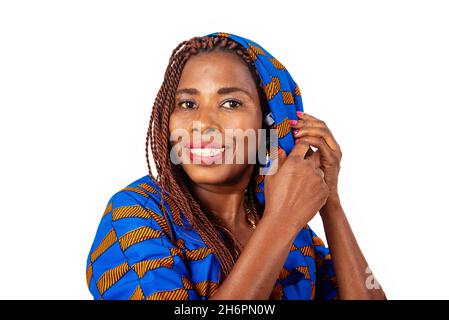 beautiful adult woman wearing a traditional loincloth tying her scarf over her head smiling Stock Photo