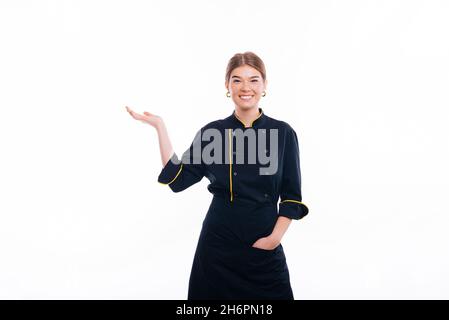 Cooking concept - happy smiling female chef holding something on palm of hand over white background Stock Photo