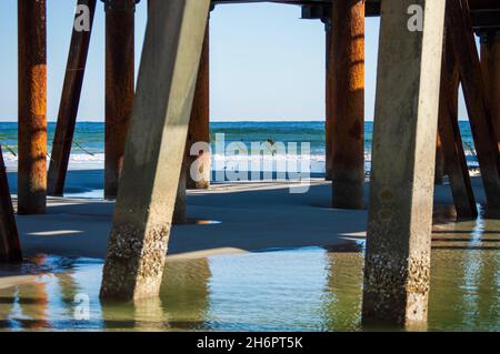 Closeup image showing the old and the new pier construction on Jacksonville Beach on a calm sunny winter morning.. Stock Photo