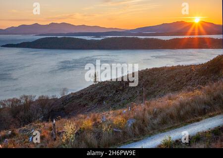 Sunset over Ardmucknish bay and a distant isle of Mull from Ben Lora, Argyll Stock Photo